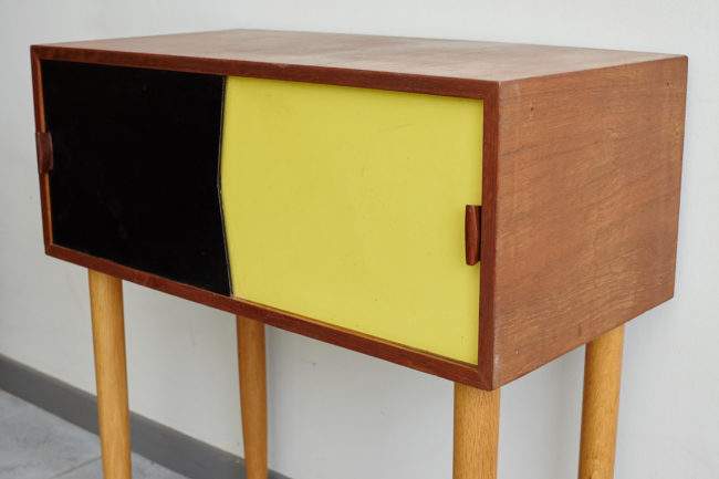 Black and yellow Swedish dresser at an angle