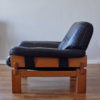 Side view of Brazilian armchair in wood and black leather