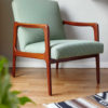 Danish mid-century green armchair in a room