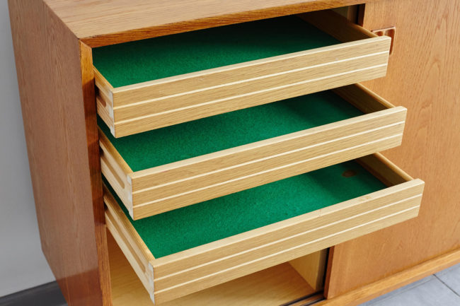 Left drawers opened of Danish oak sideboard