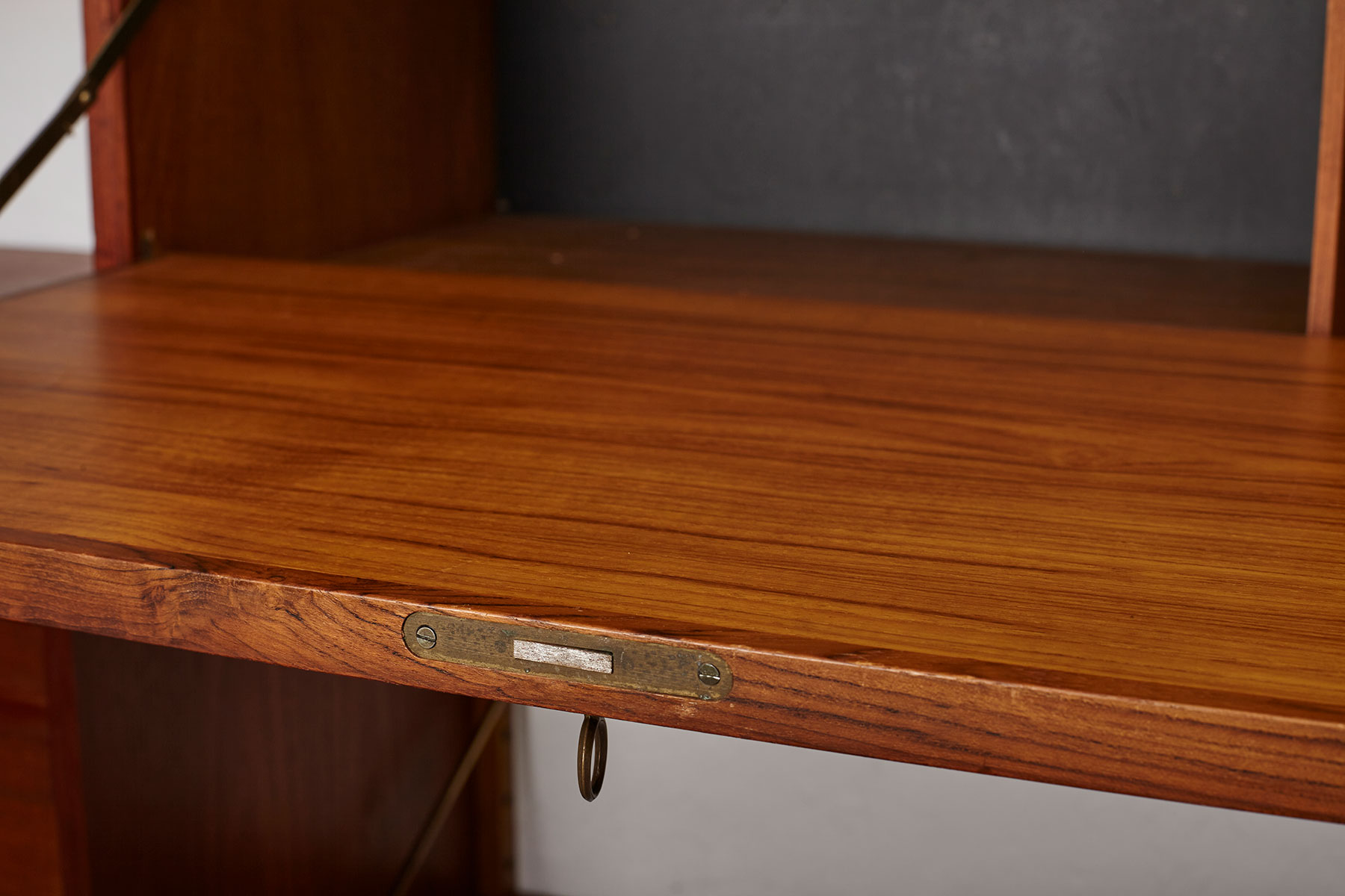 Poul Cadovius Royal System Wall Unit in teak Wood mounted to a white wall