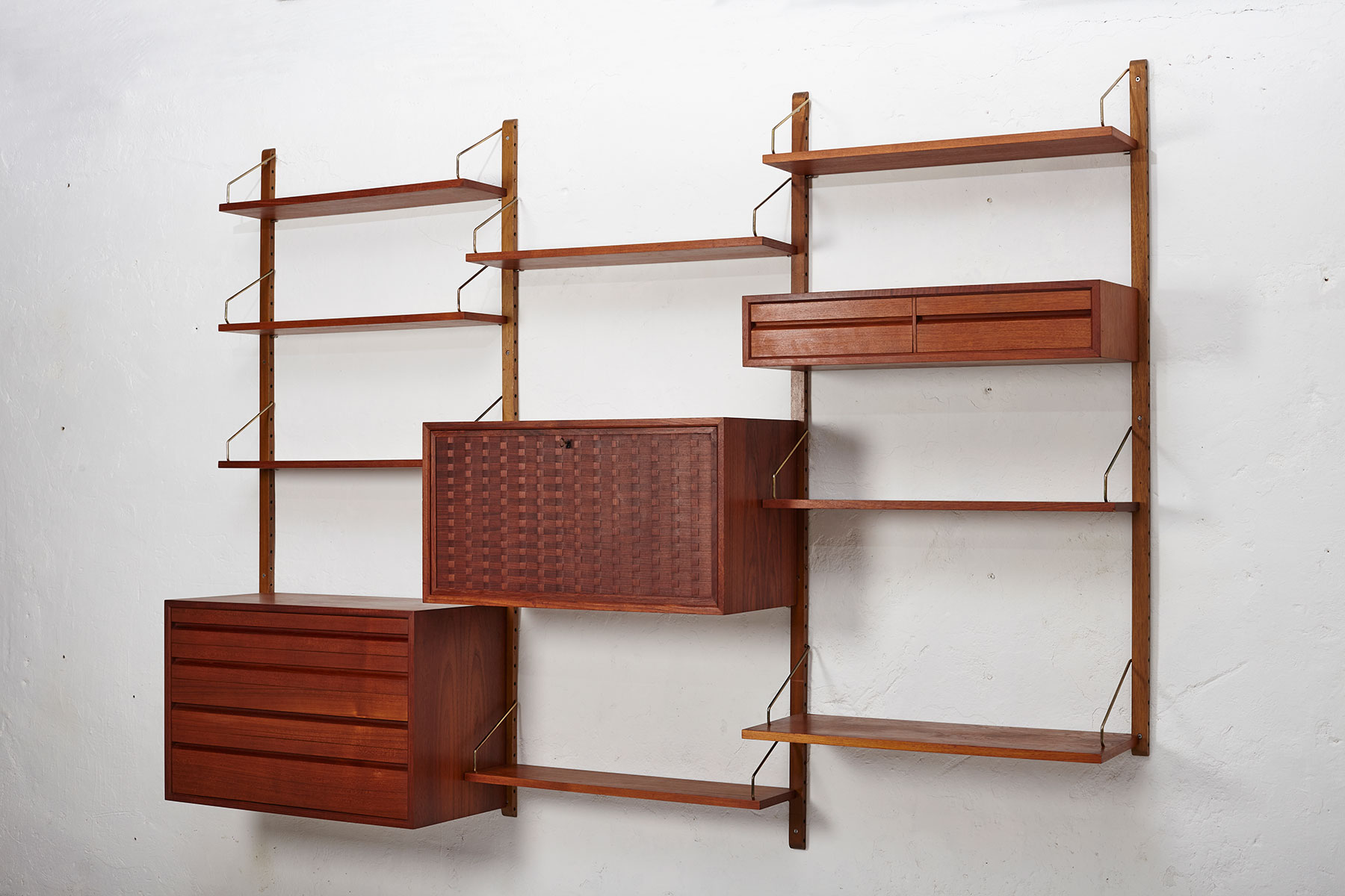 Poul Cadovius Royal System Wall Unit in teak Wood mounted to a white wall