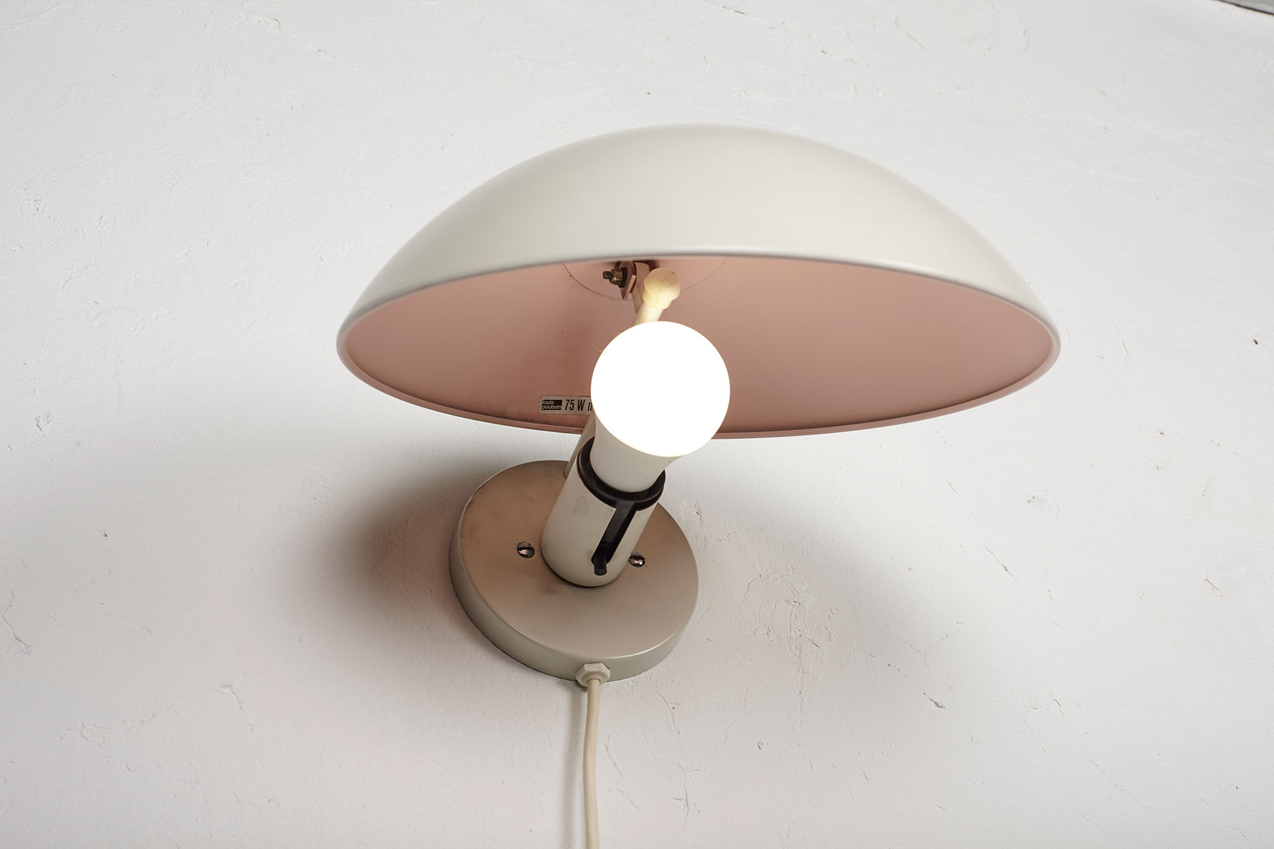 P Hat wall lamps mounted on a white wall