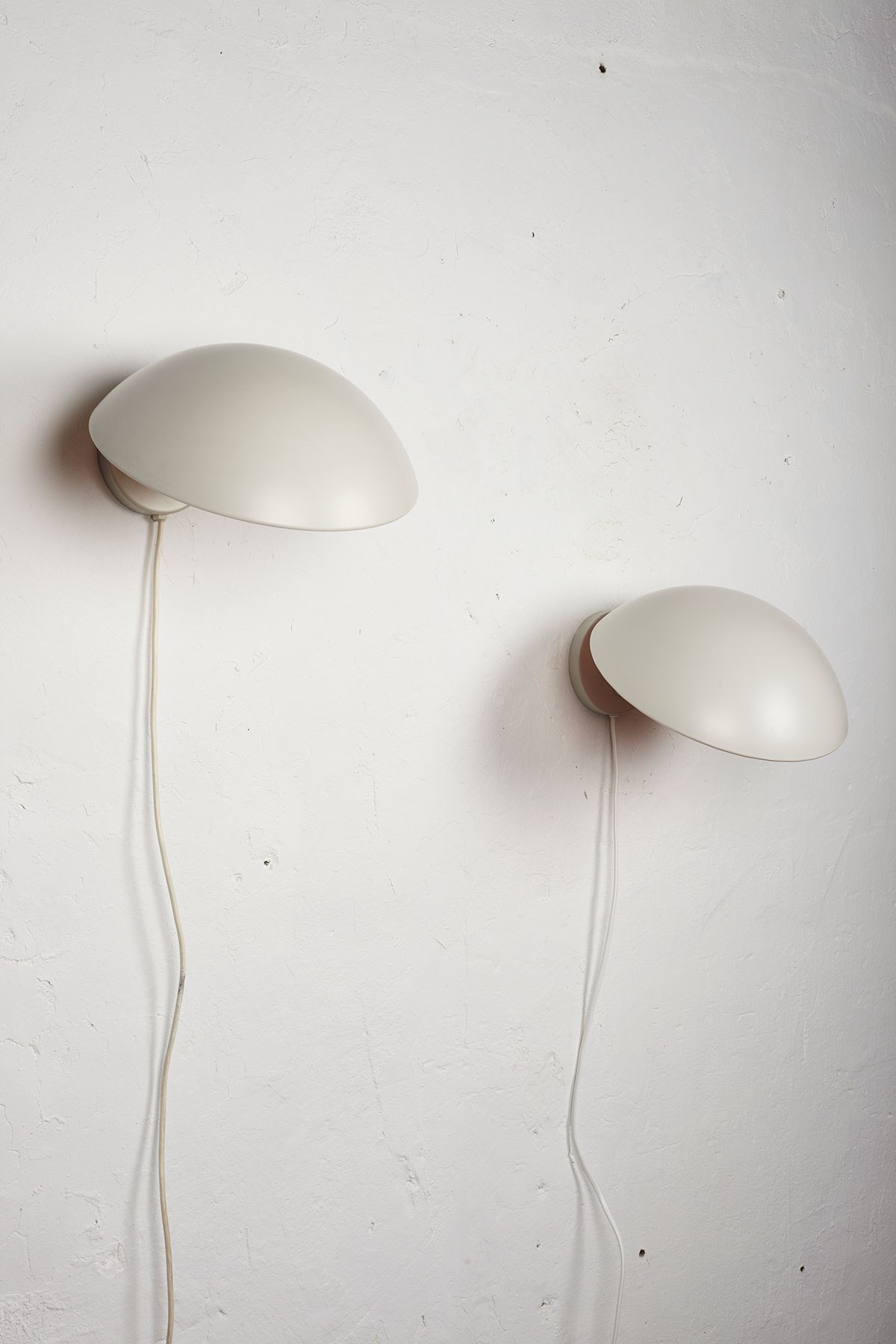 Set of two P Hat wall lamps mounted on a white wall