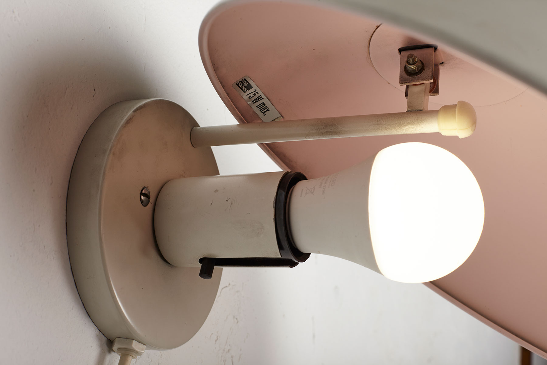 P Hat wall lamps mounted on a white wall