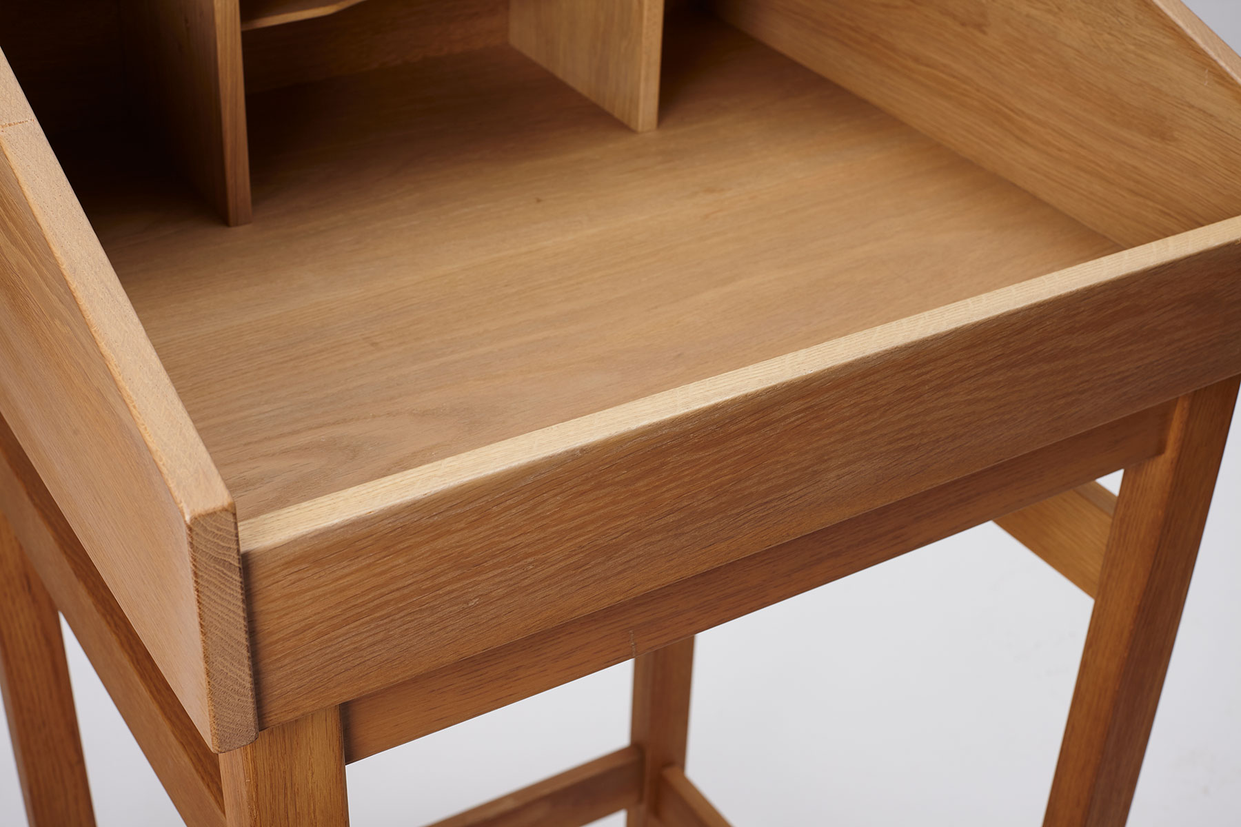 yw_danish_oak_secretary_desk_corner_detail Tall danish oak secretary desk in oak, photographed on a white background - details of the inside of the desk showing the shelves