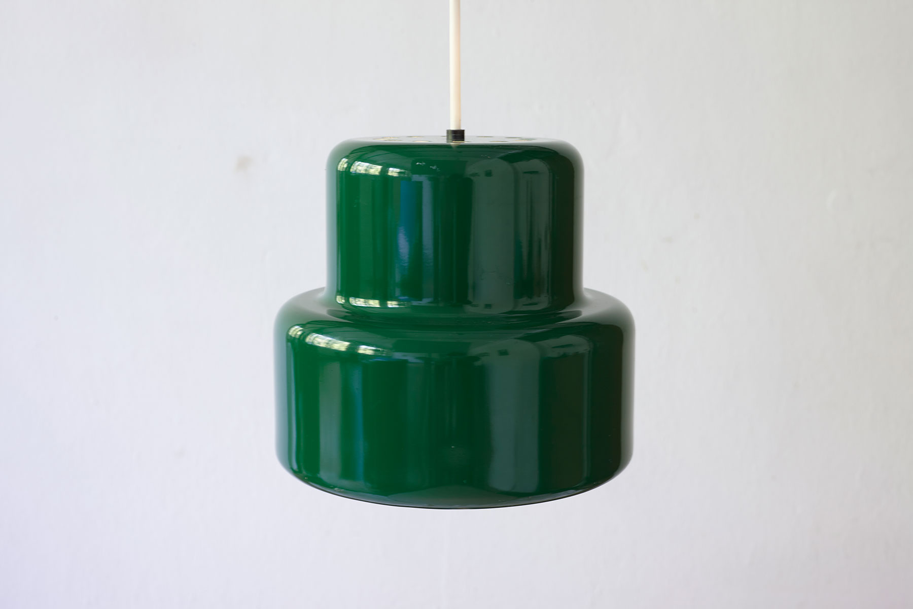 Poker Mini Pendant Light designed by Jo Hammerborg for Fog & Mørup, in a green colour featured on a white background